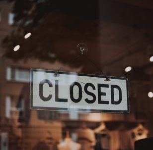 closed sign on window of business