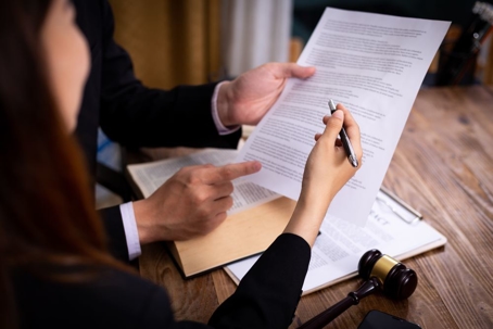 Woman going over Divorce paper with lawyer